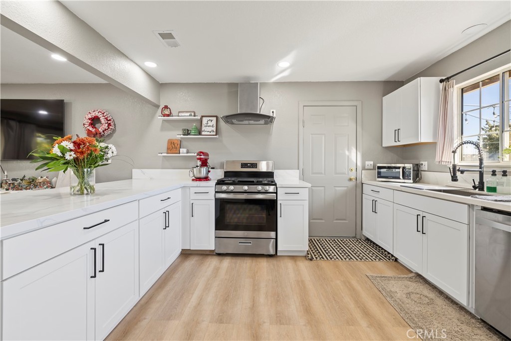 8755 Devon Avenue Hesperia, CA 92345 - Photo 12 of 45 a kitchen with granite countertop a white stove top oven and sink