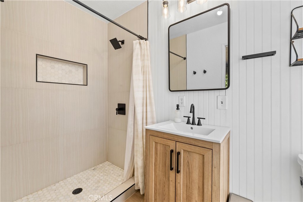 8755 Devon Avenue Hesperia, CA 92345 - Photo 17 of 45 a bathroom with a sink a mirror a vanity and a shower