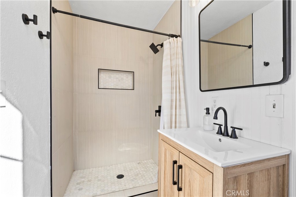 8755 Devon Avenue Hesperia, CA 92345 - Photo 18 of 45 a bathroom with a shower sink and mirror