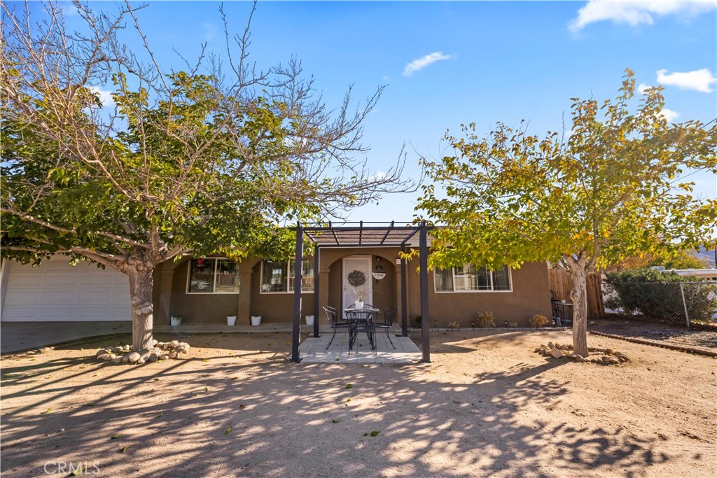 8755 Devon Avenue Hesperia, CA 92345 - Photo 40 of 45 a front view of a house with a yard and tree s