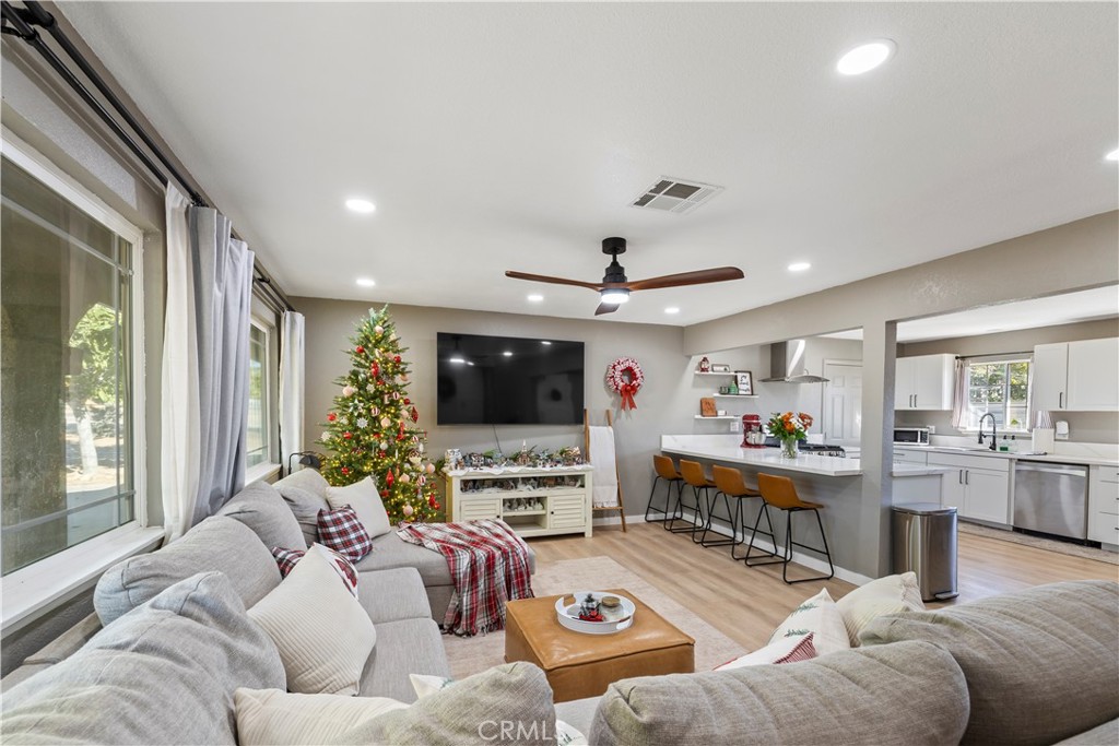 8755 Devon Avenue Hesperia, CA 92345 - Photo 6 of 45 a living room with furniture and a flat screen tv