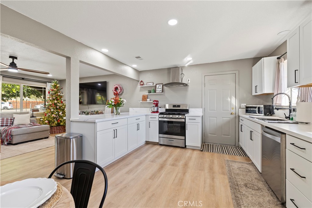 8755 Devon Avenue Hesperia, CA 92345 - Photo 9 of 45 a kitchen with white cabinets stainless steel appliances and sink