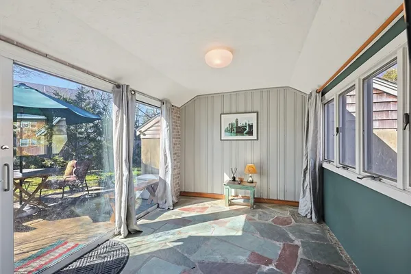 a view of a livingroom with wooden floor and a large window