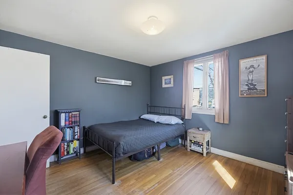 a bedroom with a bed and a chair