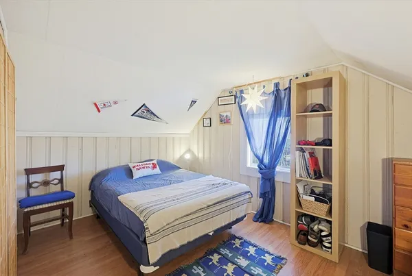 a bedroom with a bed and a book shelf