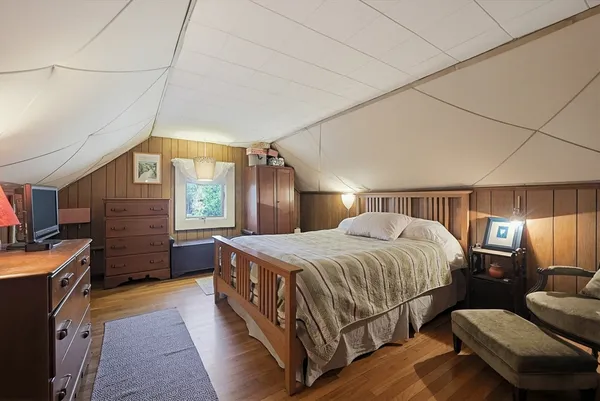 a bedroom with a bed a couch and dresser