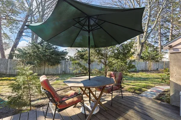 a backyard of a house with table and chairs