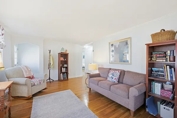 a living room with furniture and a book shelf