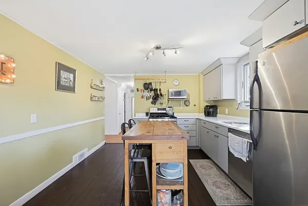 a kitchen with sink cabinets and stainless steel appliances