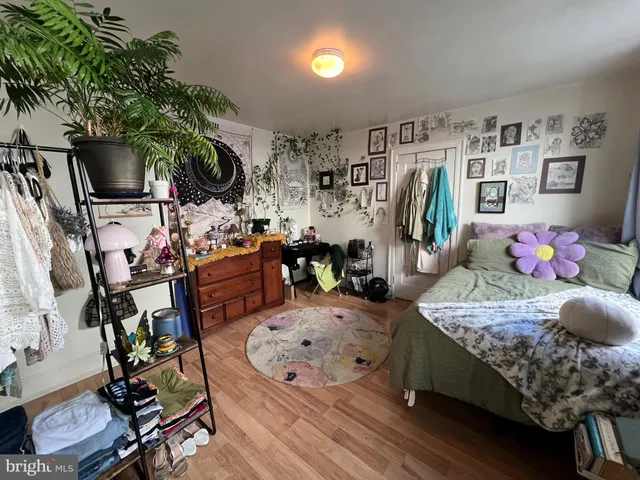 a bedroom with a bed closet and a window