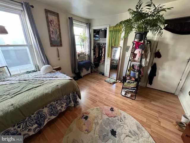 a bedroom with furniture and a flat screen tv