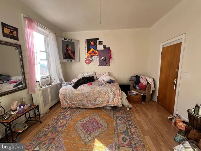 a bed sitting in a bedroom next to a window