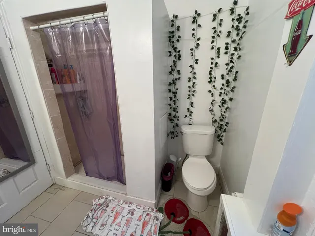 a bathroom with a sink vanity mirror and toilet