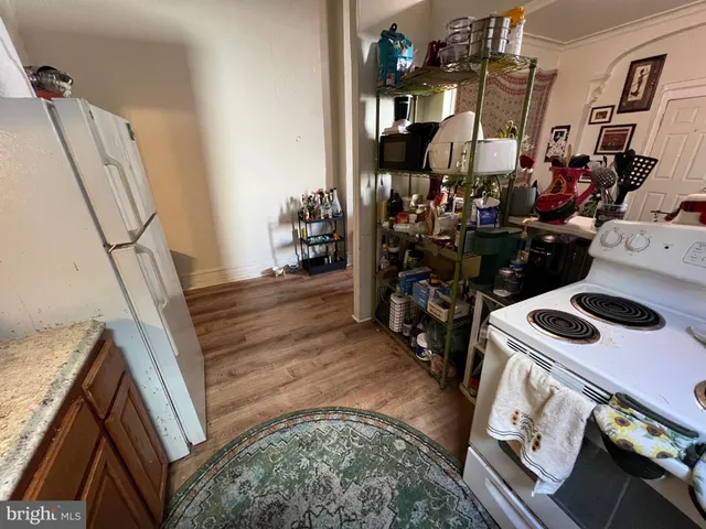a kitchen with a refrigerator and a stove