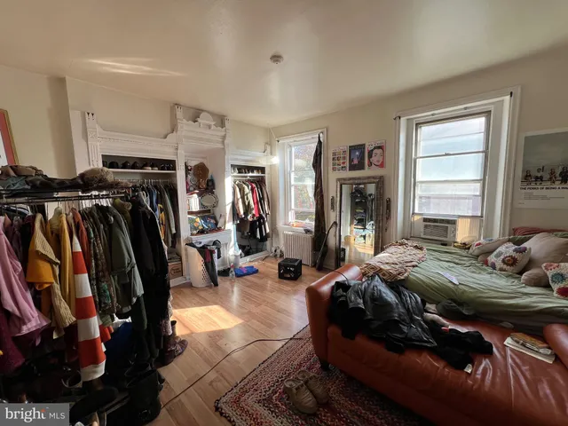 a bedroom with bed and a closet