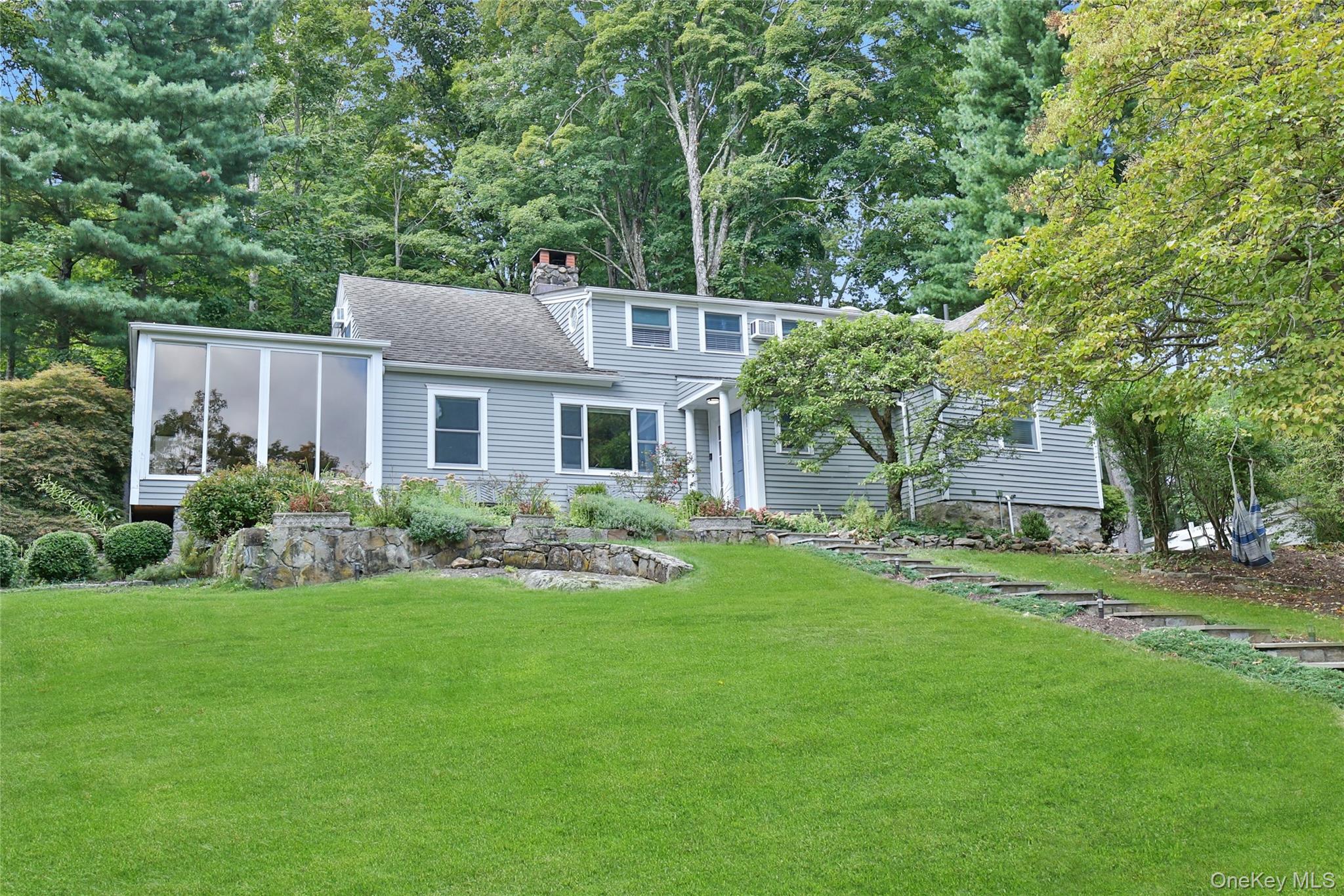 8 Old Roaring Brook Road Mount Kisco, NY 10549 - Photo 1 of 47 a front view of a house with a garden