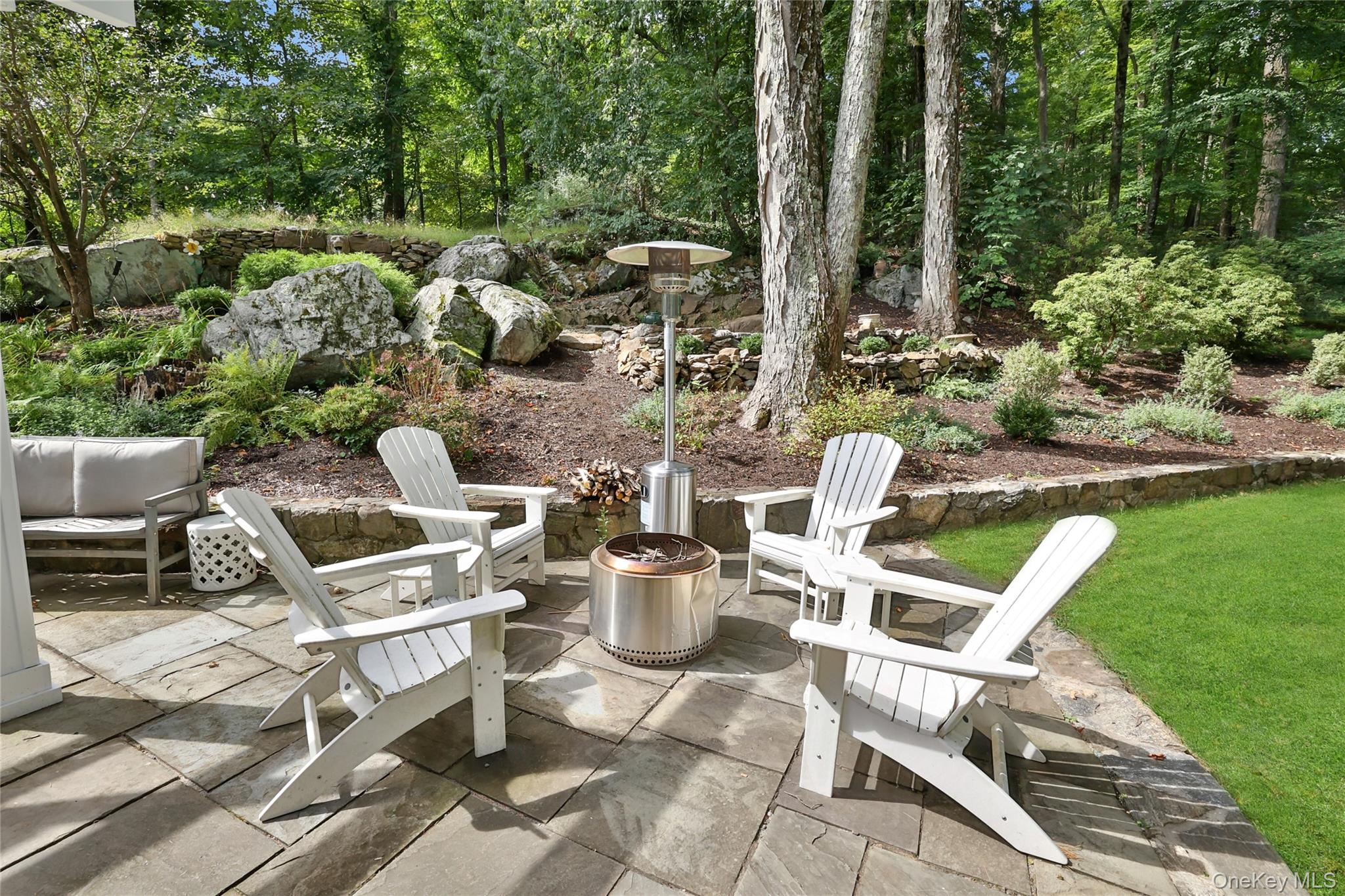 8 Old Roaring Brook Road Mount Kisco, NY 10549 - Photo 11 of 47 a view of a chairs and table in backyard