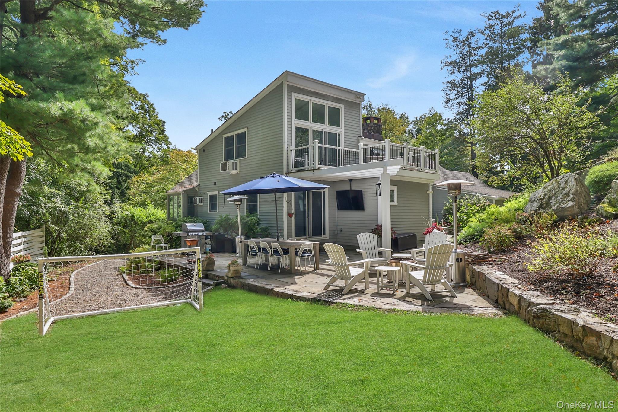 8 Old Roaring Brook Road Mount Kisco, NY 10549 - Photo 14 of 47 a front view of a house with garden