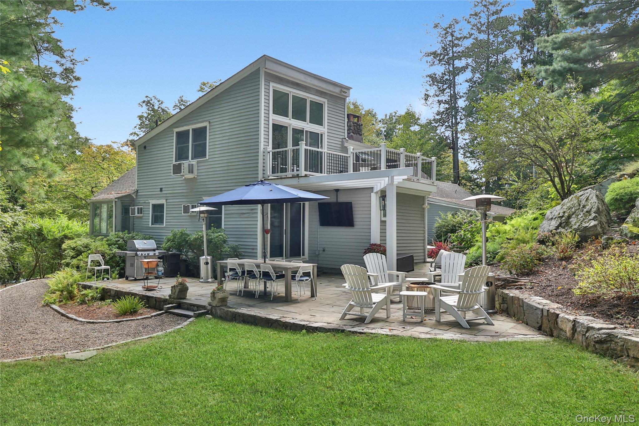 8 Old Roaring Brook Road Mount Kisco, NY 10549 - Photo 15 of 47 a front view of a house with patio and garden