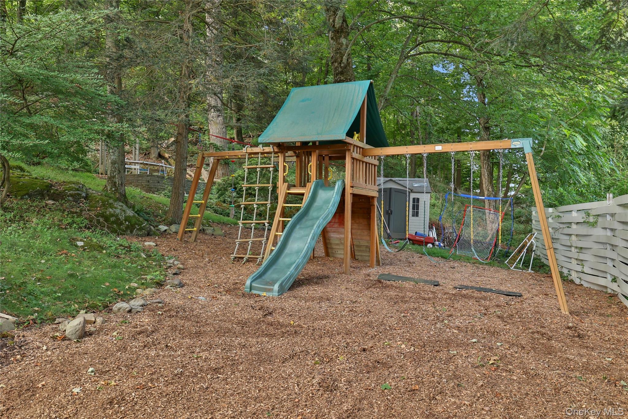 8 Old Roaring Brook Road Mount Kisco, NY 10549 - Photo 16 of 47 a view of a yard with a slide and a slide