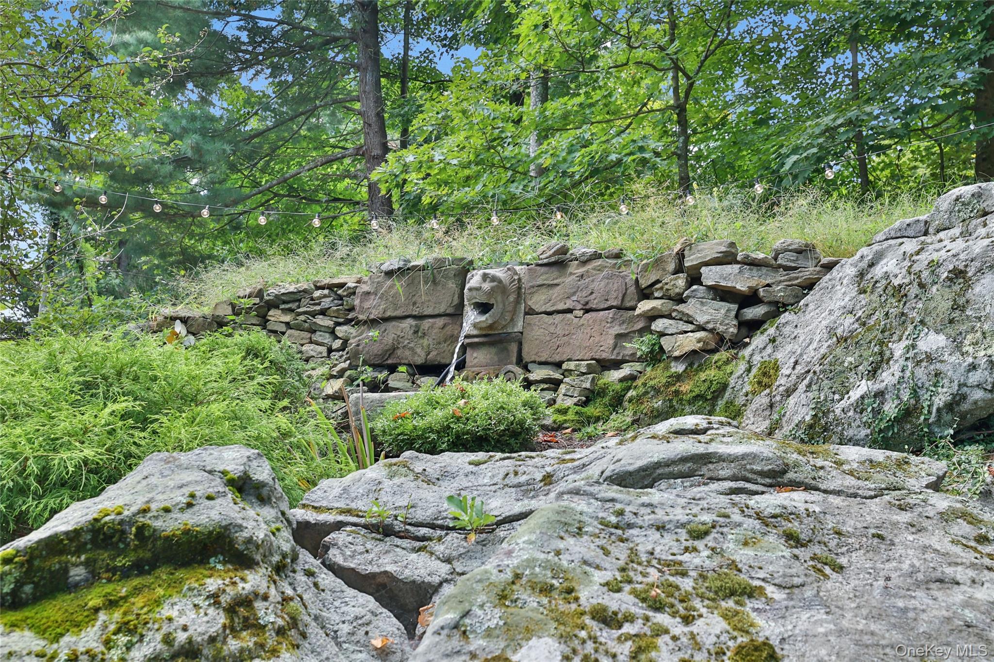 8 Old Roaring Brook Road Mount Kisco, NY 10549 - Photo 19 of 47 a view of a large yard with plants and large trees