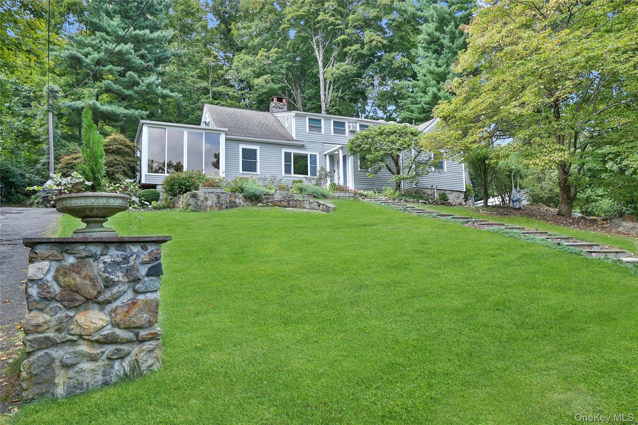 8 Old Roaring Brook Road Mount Kisco, NY 10549 - Photo 2 of 47 a front view of a house with garden
