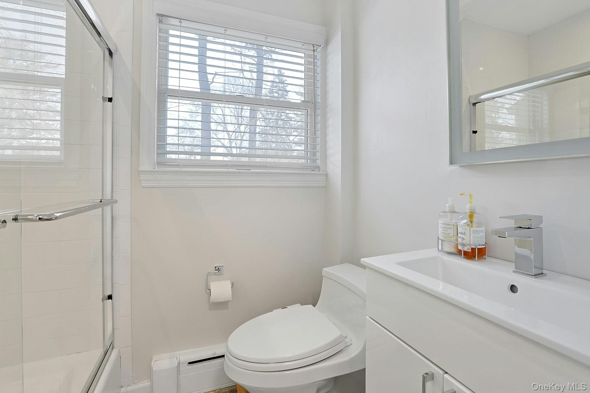 8 Old Roaring Brook Road Mount Kisco, NY 10549 - Photo 39 of 47 a bathroom with a sink a toilet and a window