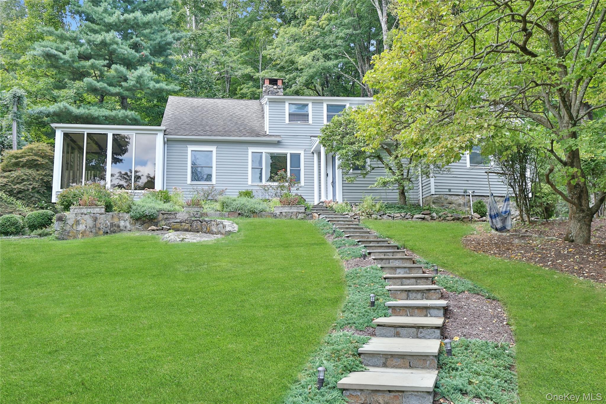 8 Old Roaring Brook Road Mount Kisco, NY 10549 - Photo 4 of 47 a front view of a house with a yard