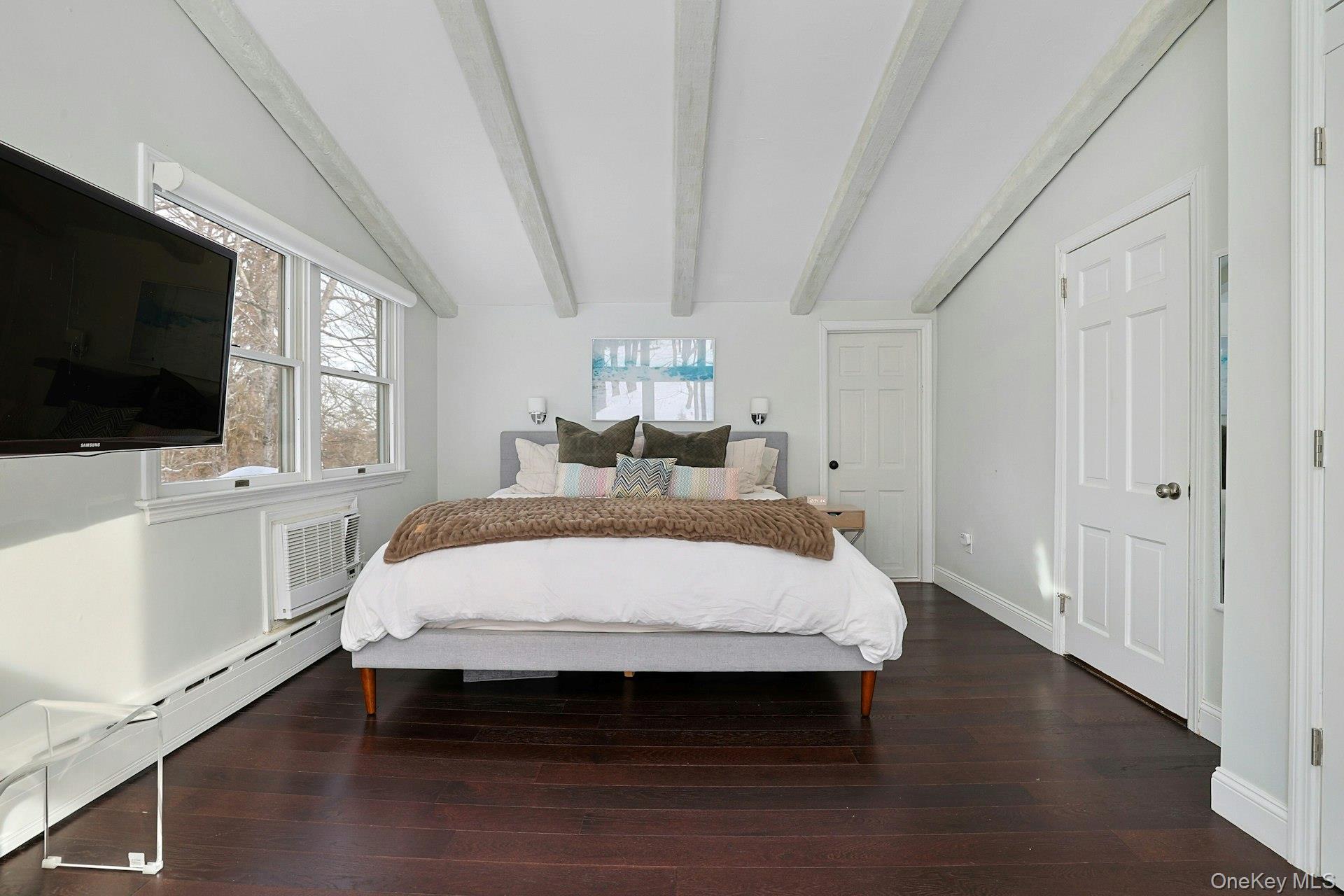 8 Old Roaring Brook Road Mount Kisco, NY 10549 - Photo 45 of 47 a bed sitting in a spacious bedroom next to a window with pc on the table