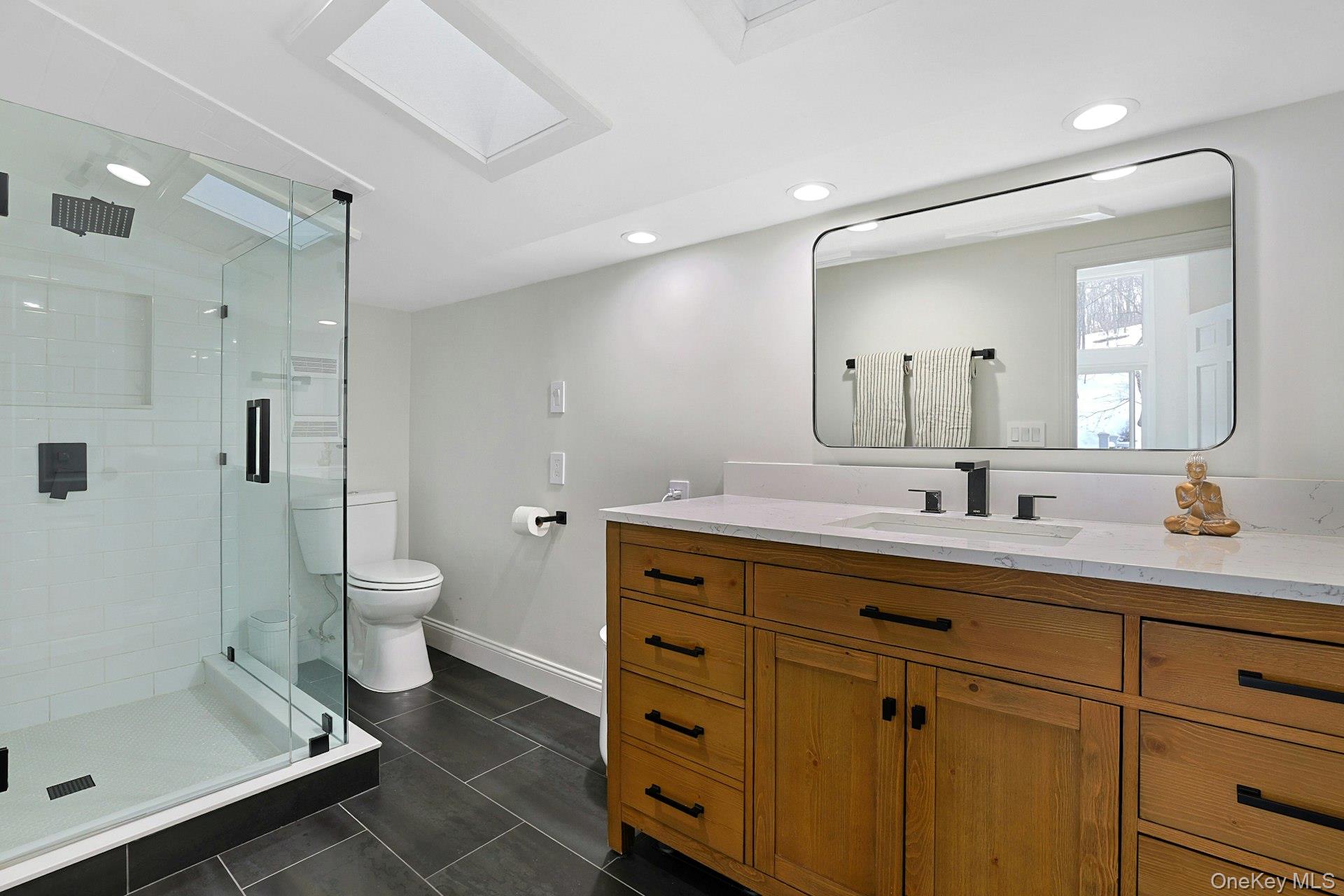 8 Old Roaring Brook Road Mount Kisco, NY 10549 - Photo 47 of 47 a bathroom with a double vanity sink toilet and shower