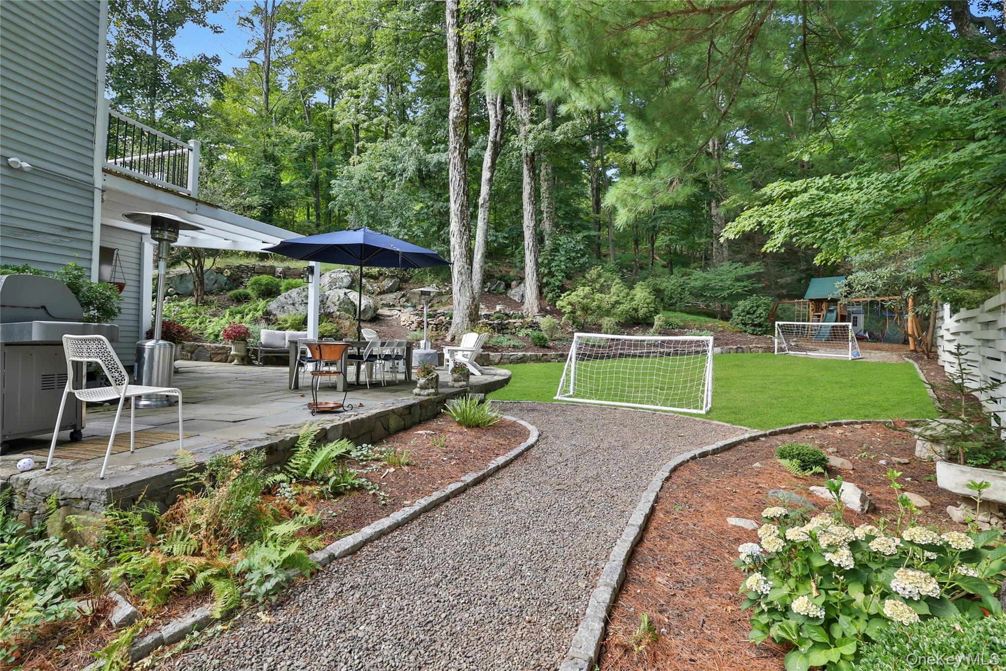 8 Old Roaring Brook Road Mount Kisco, NY 10549 - Photo 7 of 47 a view of a garden with a patio