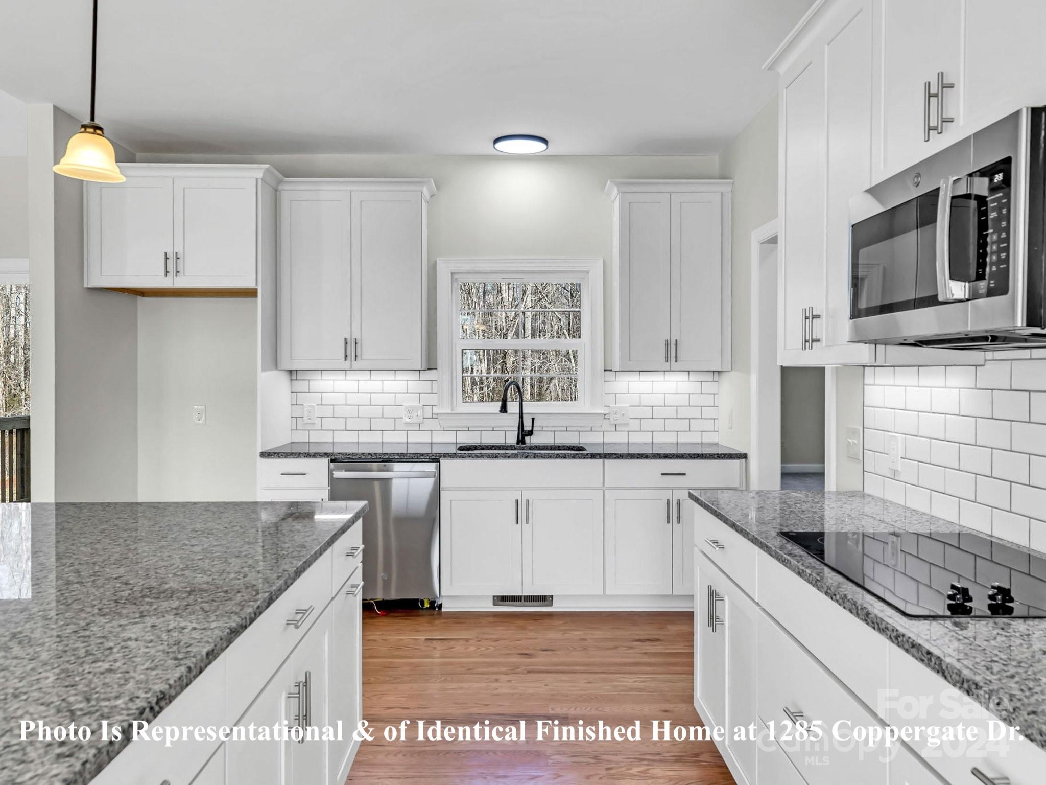 1375 Coppergate Drive Salisbury, NC 28147 - Photo 14 of 41 a kitchen with stainless steel appliances granite countertop a sink stove and microwave