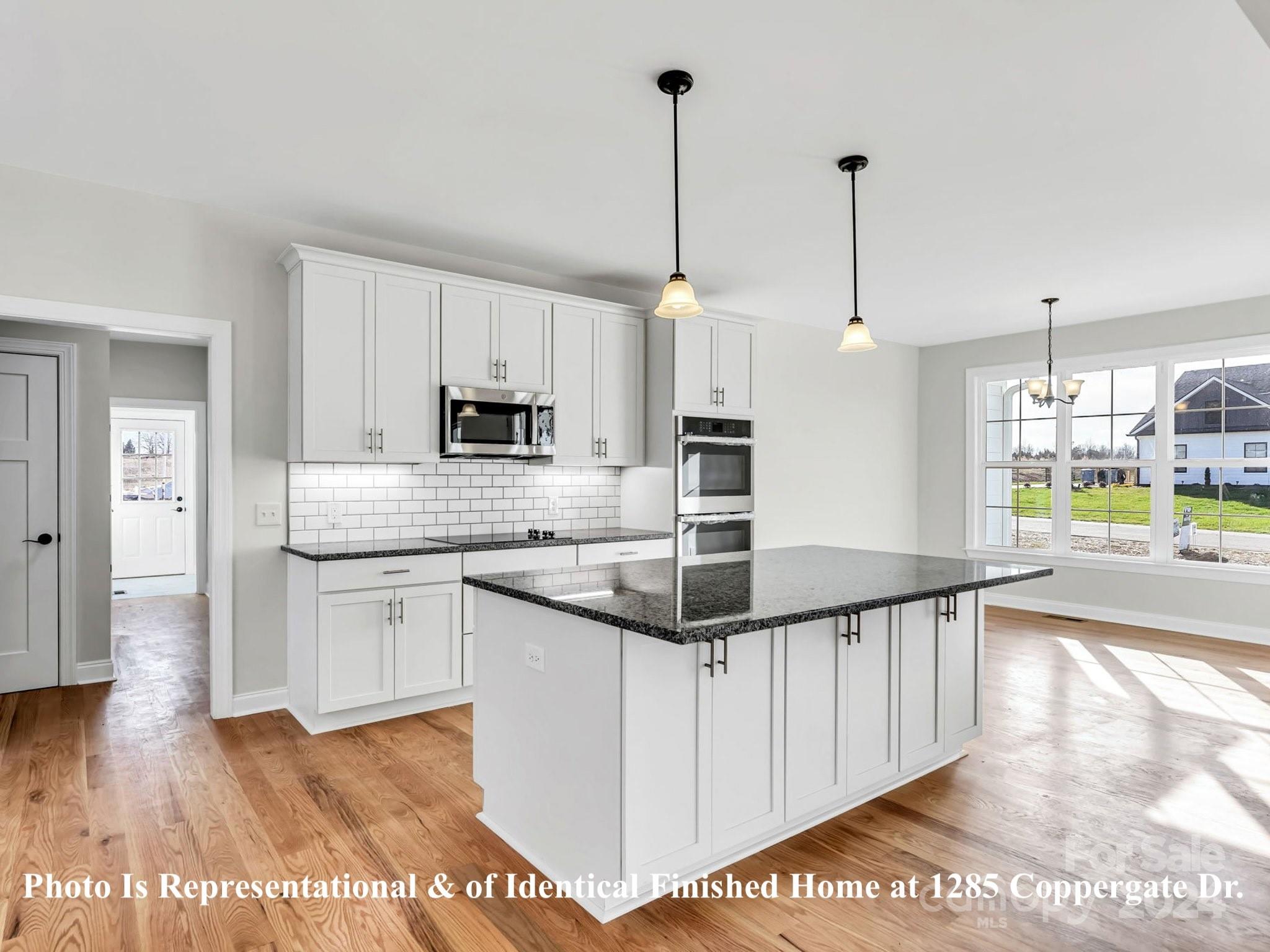 1375 Coppergate Drive Salisbury, NC 28147 - Photo 15 of 41 a kitchen with stainless steel appliances kitchen island granite countertop a sink a counter top space and cabinets