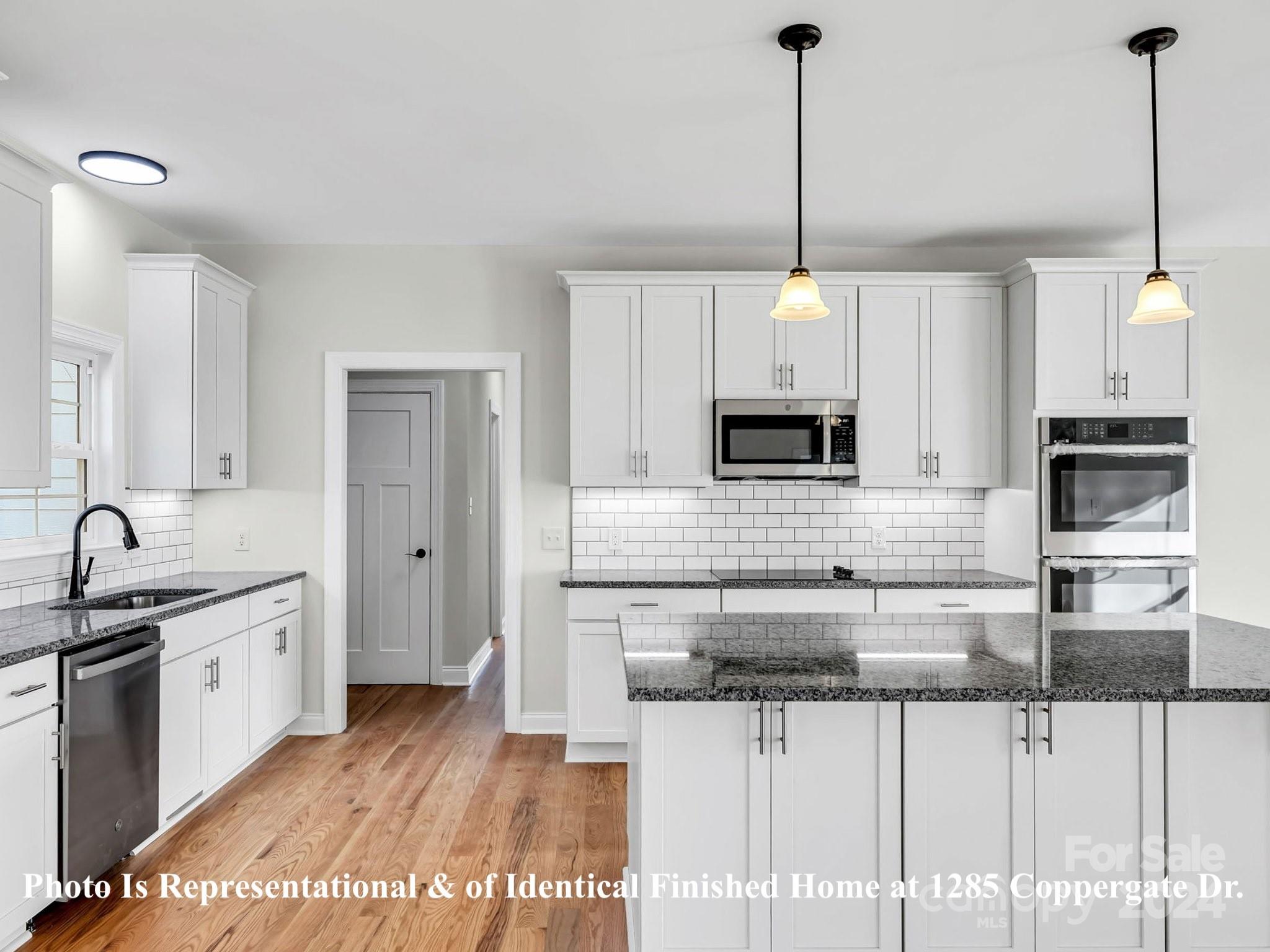 1375 Coppergate Drive Salisbury, NC 28147 - Photo 16 of 41 a kitchen with stainless steel appliances kitchen island granite countertop a stove sink and cabinets
