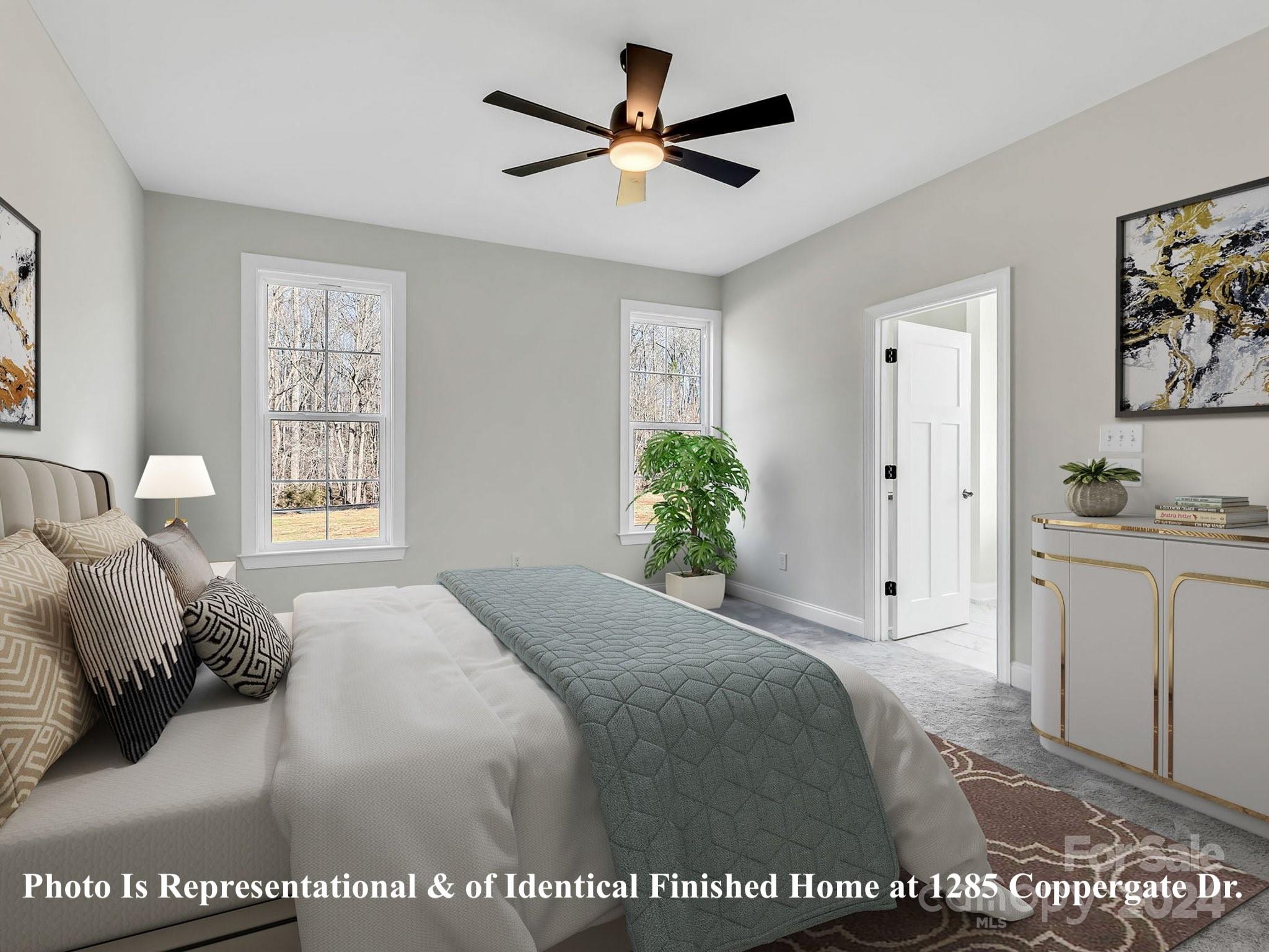 1375 Coppergate Drive Salisbury, NC 28147 - Photo 25 of 41 a spacious bedroom with a bed a couch and a window