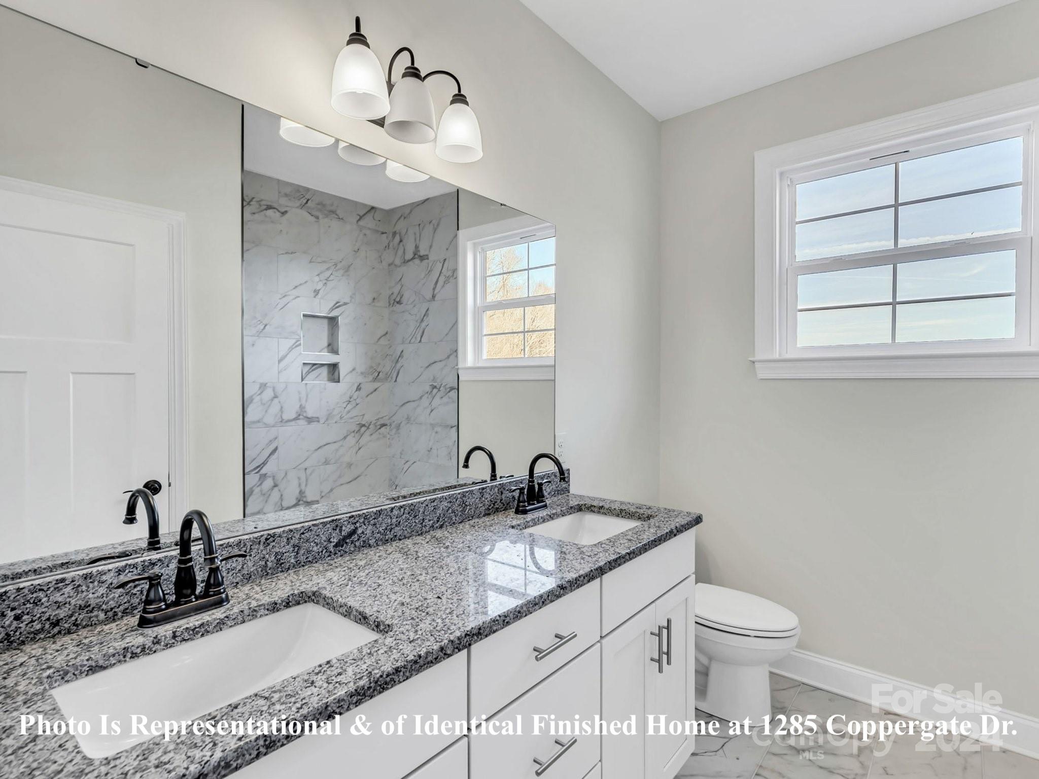 1375 Coppergate Drive Salisbury, NC 28147 - Photo 39 of 41 a bathroom with a granite countertop sink toilet and mirror
