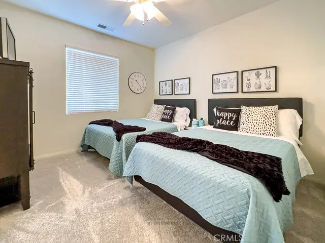 a bedroom with a bed and a lamp