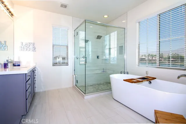 a bathroom with a tub sink and shower