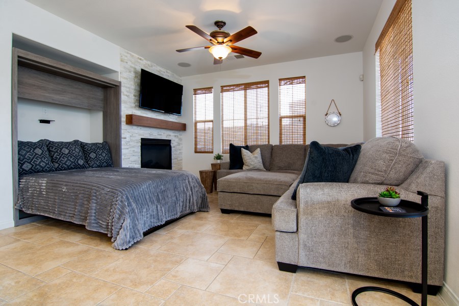 43183 Bacino Court Indio, CA 92203 - Photo 20 of 20 a living room with furniture a fireplace and a flat screen tv