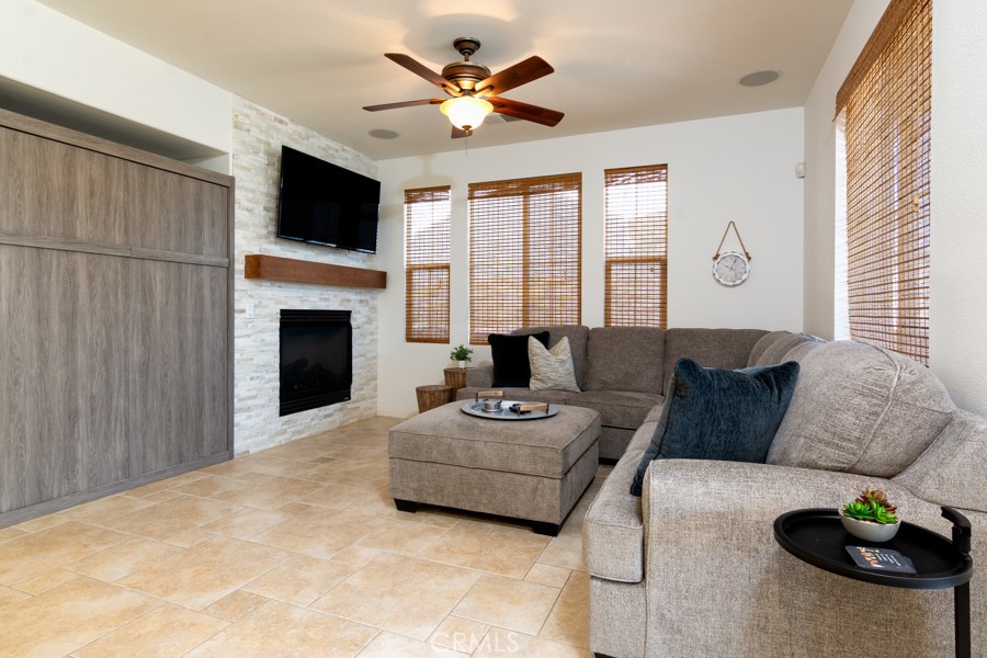 43183 Bacino Court Indio, CA 92203 - Photo 3 of 20 a living room with furniture a fireplace and a flat screen tv