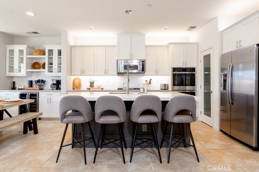 43183 Bacino Court Indio, CA 92203 - Photo 8 of 20 a kitchen with stainless steel appliances granite countertop a sink a stove a refrigerator and chairs