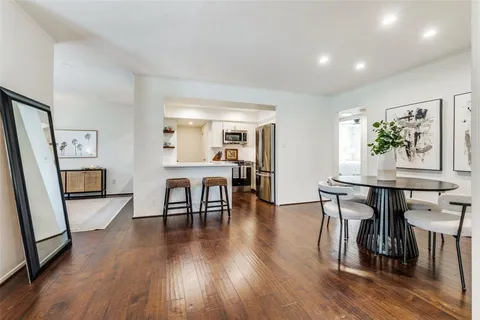 a dining room with furniture and wooden floor