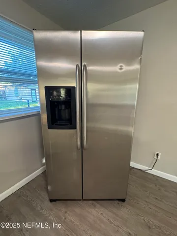 a view of a room with wooden floor