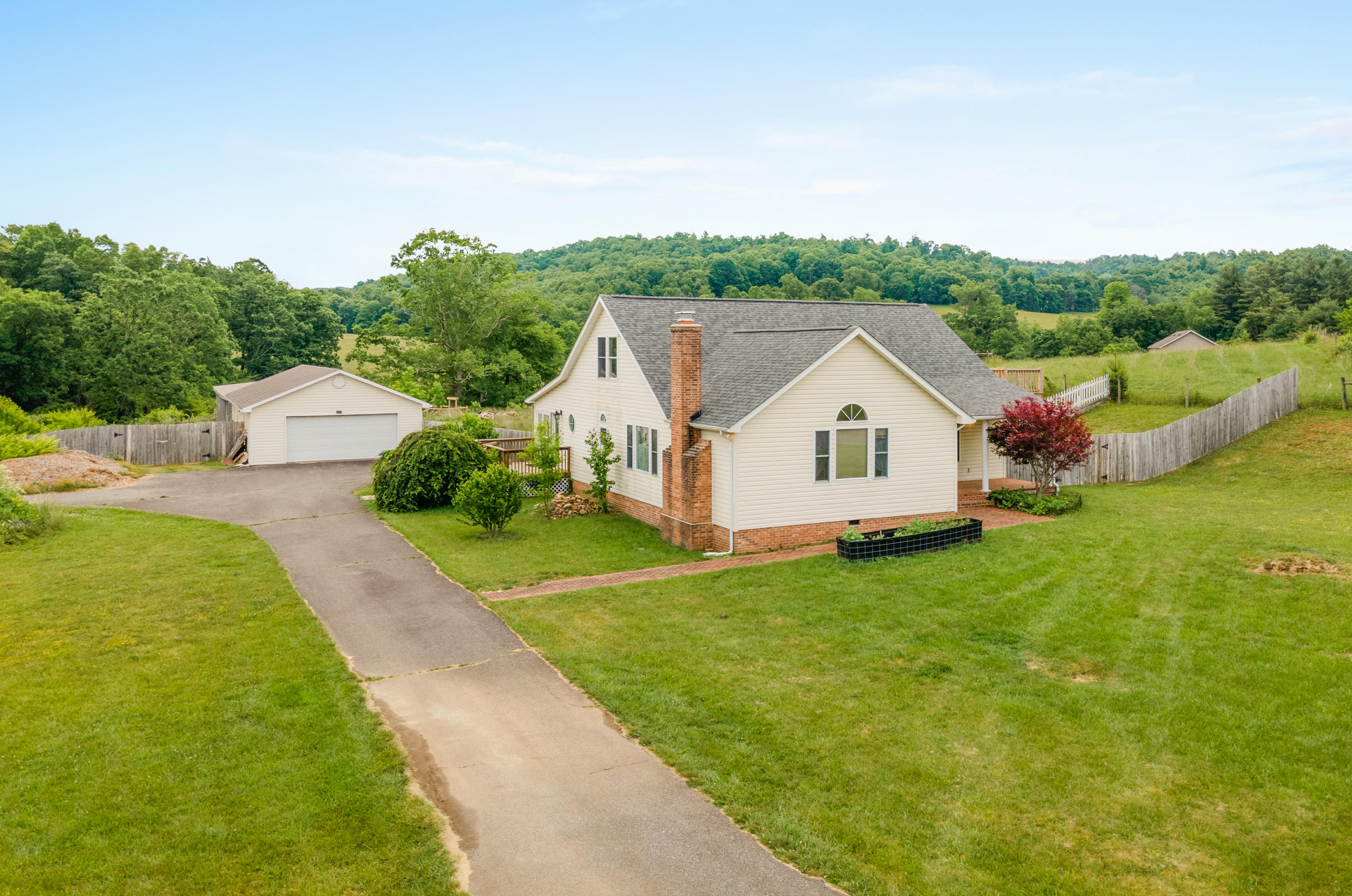 223 Conner Grove Road Southwest Willis, VA 24380 - Photo 1 of 74 a house with green field in front of it