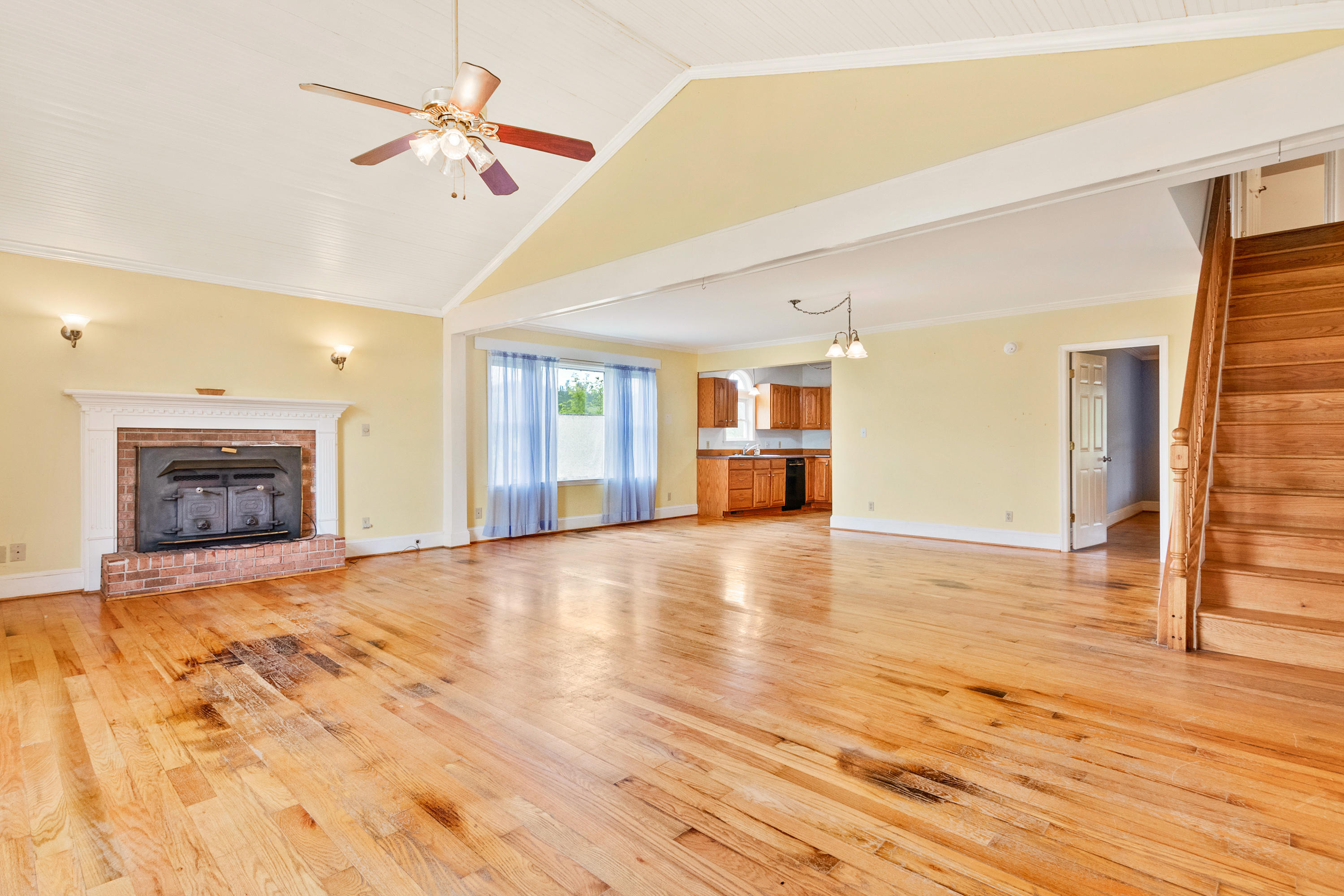 223 Conner Grove Road Southwest Willis, VA 24380 - Photo 25 of 74 a view of an empty room with wooden floor fireplace and a window
