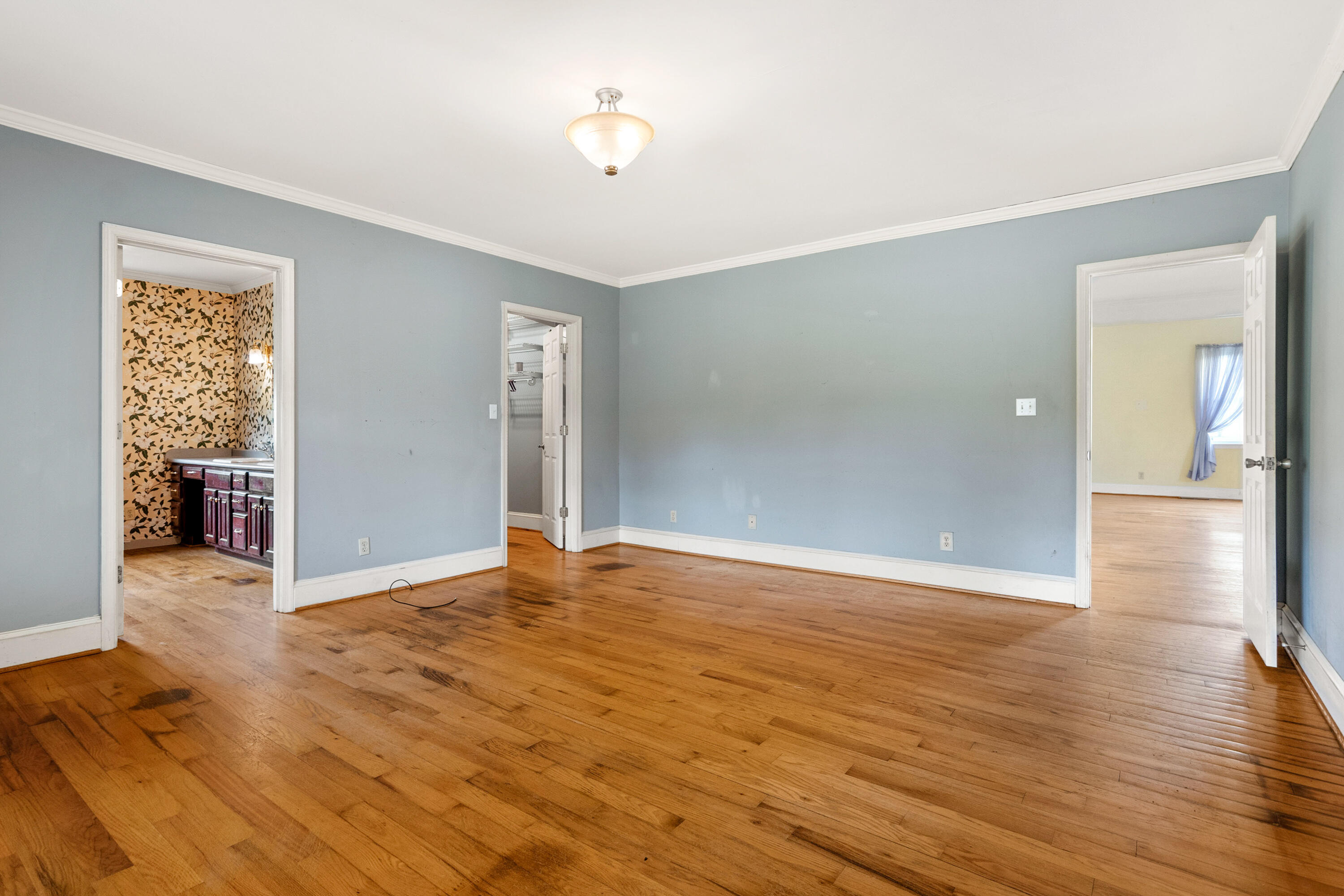 223 Conner Grove Road Southwest Willis, VA 24380 - Photo 28 of 74 a view of an empty room with wooden floor and a window