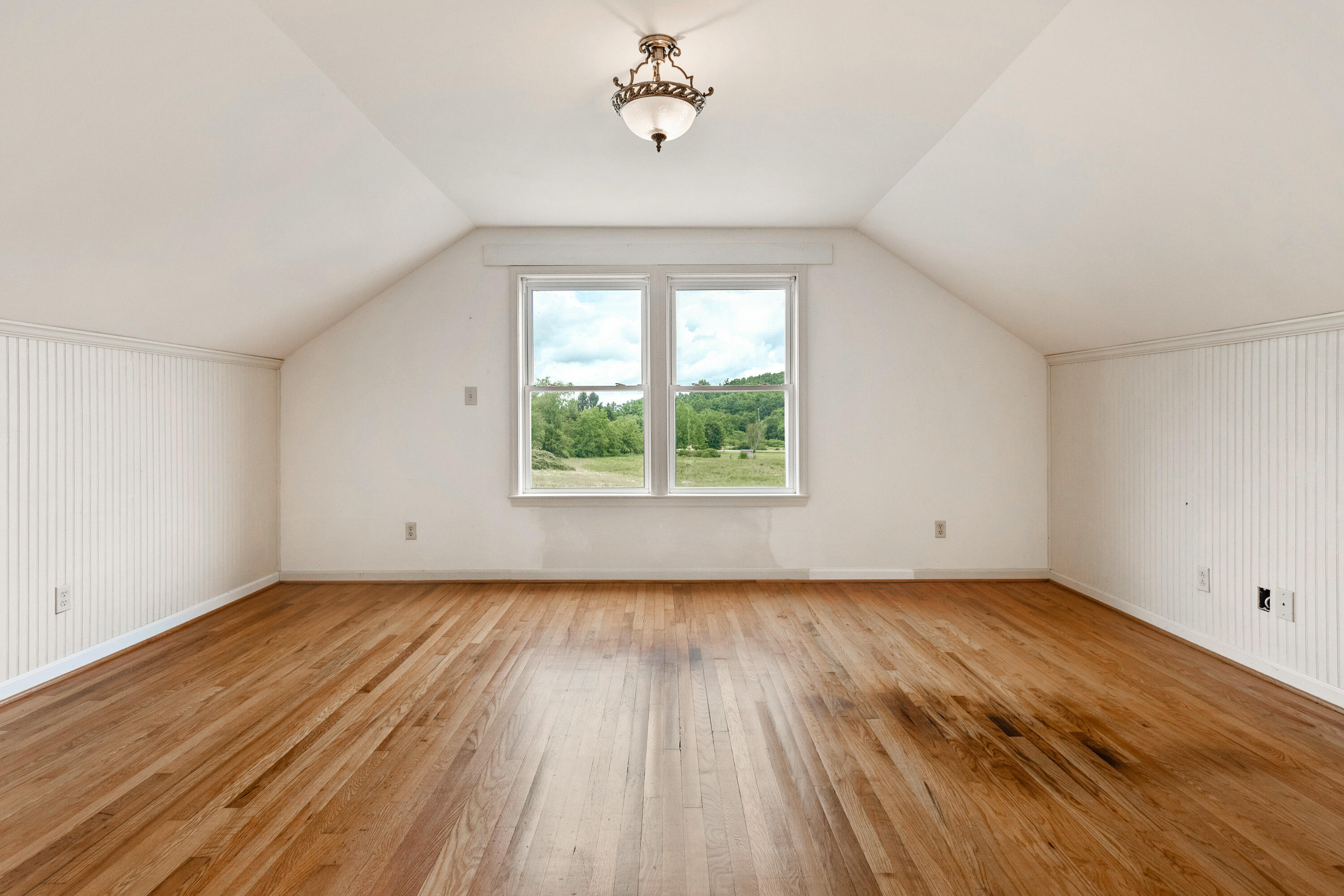 223 Conner Grove Road Southwest Willis, VA 24380 - Photo 37 of 74 an empty room with wooden floor chandelier fan and windows