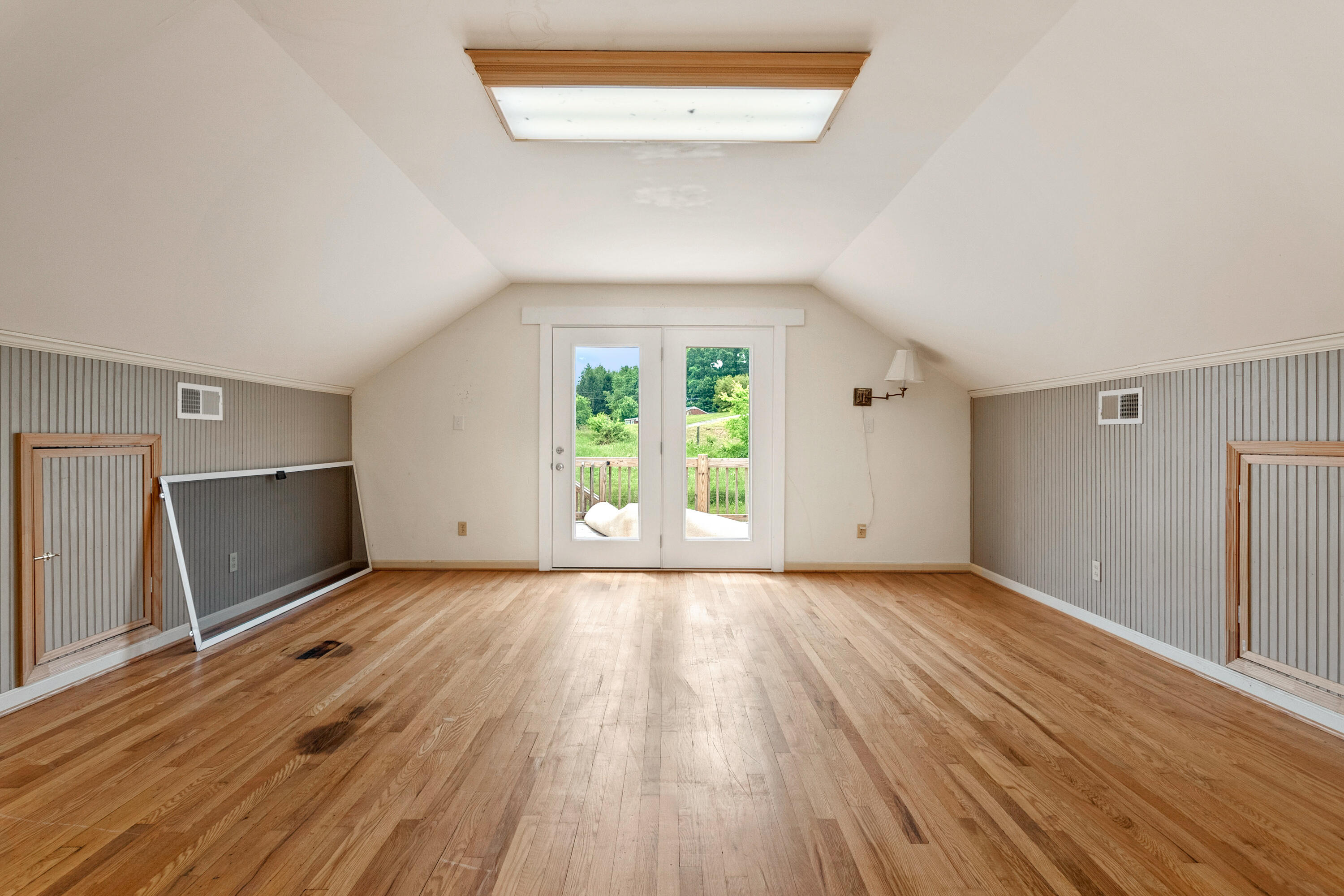 223 Conner Grove Road Southwest Willis, VA 24380 - Photo 40 of 74 a view of an empty room with wooden floor and a window