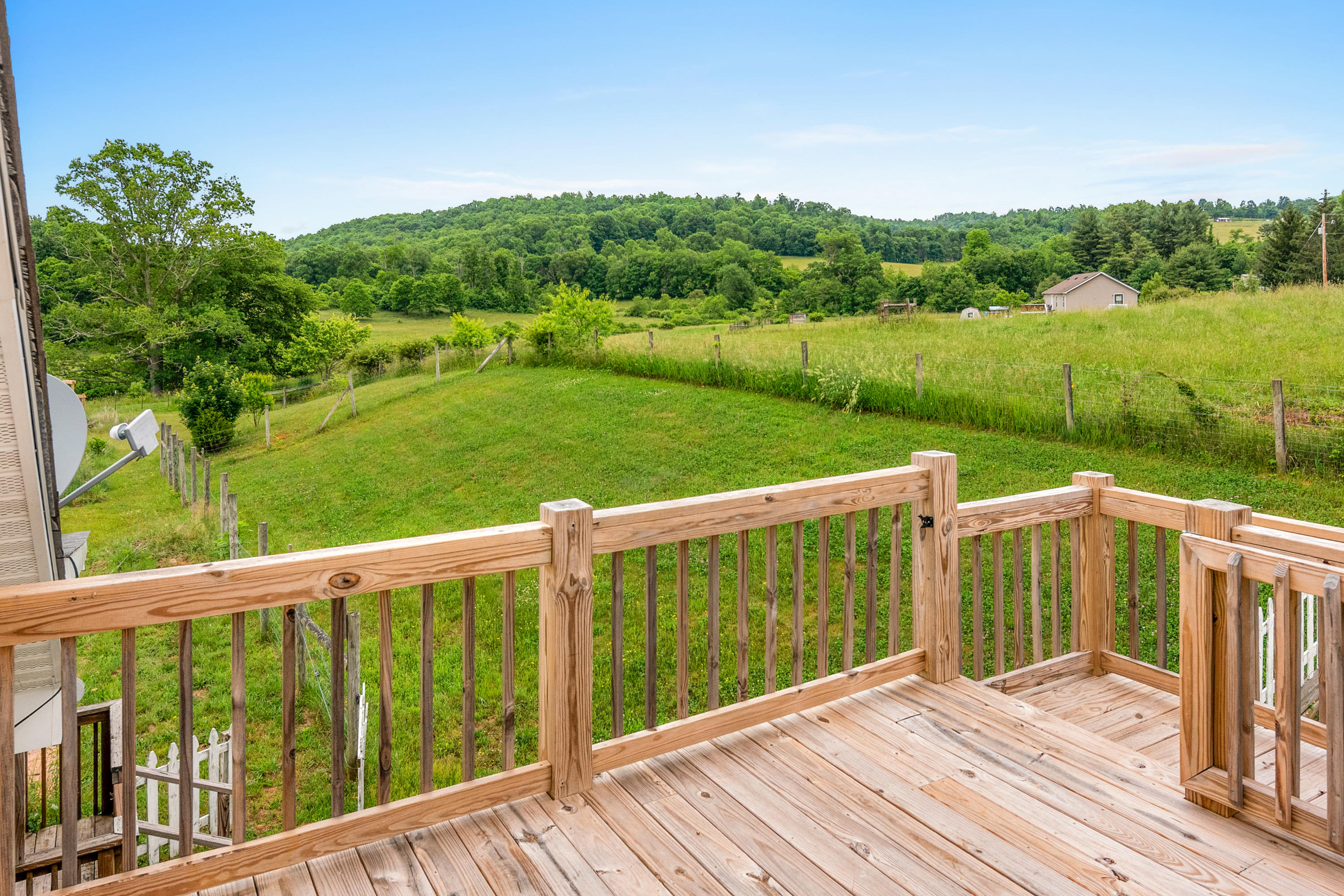 223 Conner Grove Road Southwest Willis, VA 24380 - Photo 42 of 74 a view of a wooden deck with a garden view
