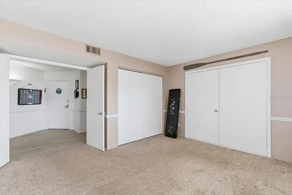 a view of a livingroom with furniture and an empty room